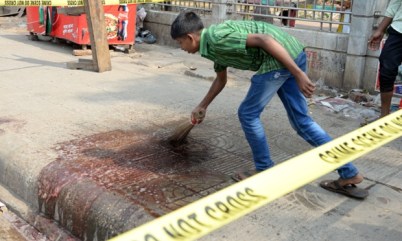 27 Feb 2015, Dhaka, Bangladesh, Bengal --- (150227) -- DHAKA, Feb. 27, 2015 (Xinhua) -- A man cleans up the blood at the site of a murder case at Dhaka University area in Dhaka, Bangladesh, Feb. 27, 2015. Unknown assailants Thursday night hacked a Bangladeshi blogger to death in the capital city of Dhaka. (Xinhua/Shariful Islam) --- Image by © Shariful Islam/Xinhua Press/Corbis