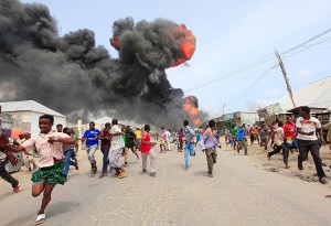 People escape from the direction of a huge fire-ball after an accidental explosion at a petrol storage facility within the former United States residential housing in capital Mogadishu September 3, 2013. REUTERS/Feisal Omar (SOMALIA - Tags: DISASTER ENERGY)